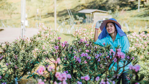 Female researcher examining flowers on land