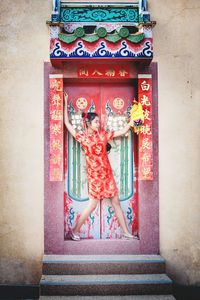 Woman standing against multi colored wall