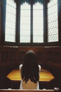 Woman looking through window