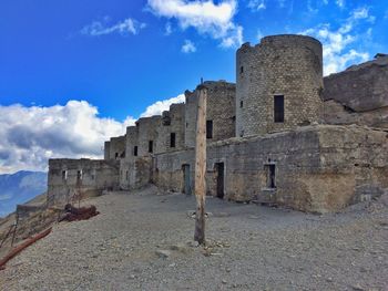 Old building against cloudy sky