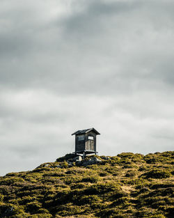 Low angle view of cabin amidst buildings against sky