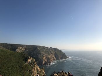 Scenic view of sea against clear blue sky