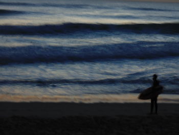 Silhouette of woman against cloudy sky