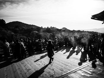 People on mountain against sky