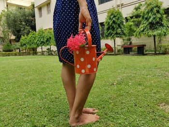 Midsection of woman standing on field