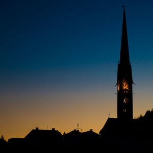 Low angle view of silhouette buildings against clear sky during sunset