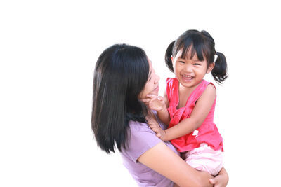 Portrait of a smiling young woman against white background