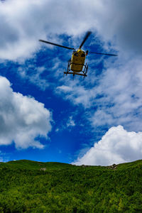 Low angle view of airplane flying against sky