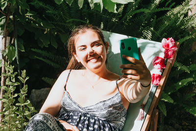 Woman taking selfie through smart phone