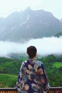 Rear view of woman looking at mountain view