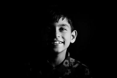 Close-up of young man against black background