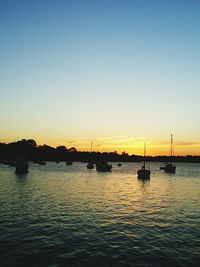 Boat in sea at sunset