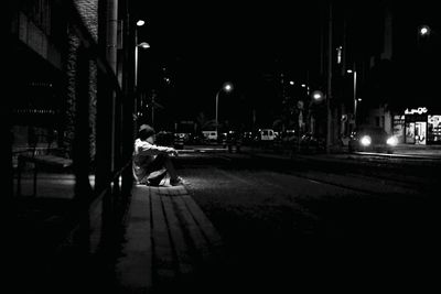 Man in city at night