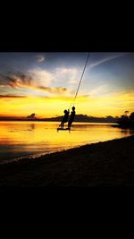 Silhouette of woman on beach at sunset