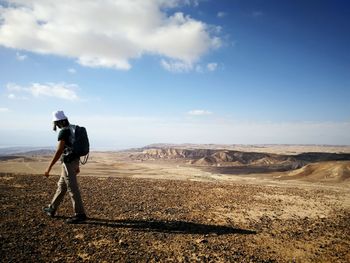 Full length side view of man standing on landscape