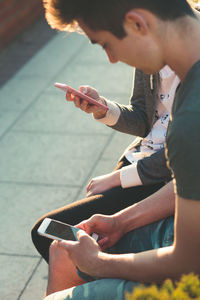 Midsection of man using mobile phone