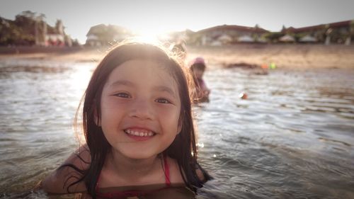 Portrait of smiling girl swimming in sea