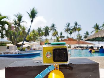 Close-up of camera by swimming pool