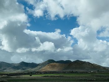 Scenic view of landscape and mountains against sky