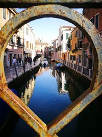 Bridge over canal amidst buildings in city