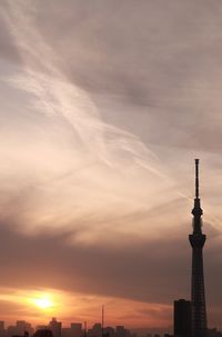 View of communications tower against cloudy sky