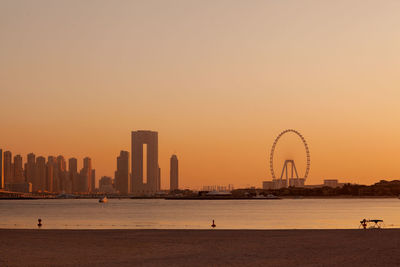 Sunset over the island of blue waters with the famous dubai eye ferris wheel