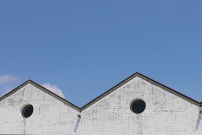 Low angle view of built structure against blue sky