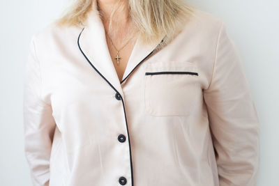 Midsection of woman standing against white background