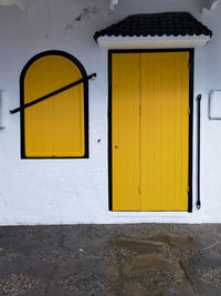 Yellow simplistic window with a yellow door in the old medina of asilah