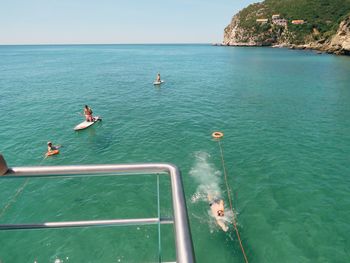 High angle view of people in sea against sky