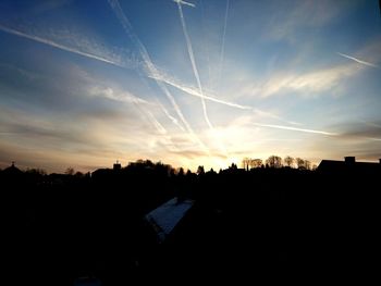 Silhouette of building against sky at sunset