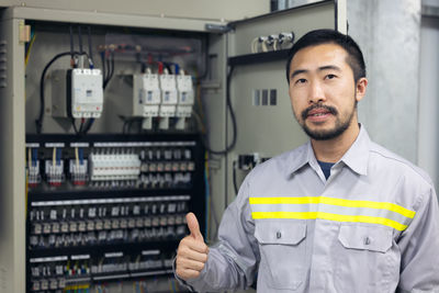 Portrait of engineer power systems in factory, industry.