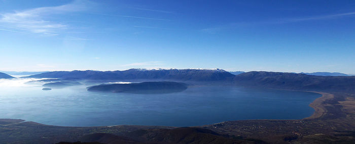 Scenic view of mountain against blue sky