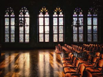 Empty chairs and tables in building