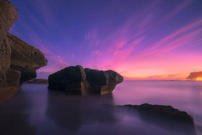 Scenic view of rock formation against sky during sunset