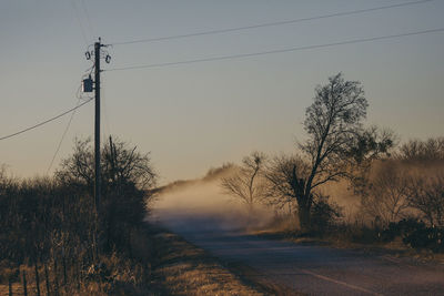 Dust on road against clear sky