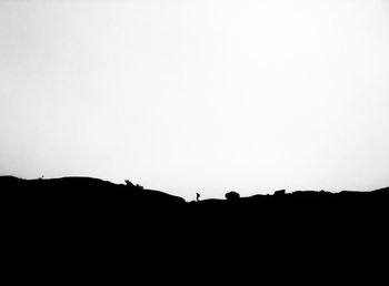 Low angle view of silhouette mountain against clear sky