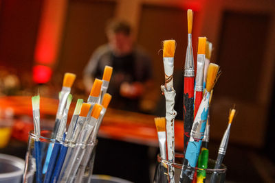 Close-up of multi colored brushes on glass