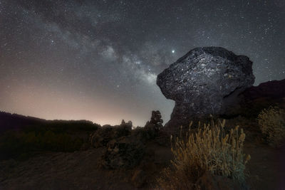 Scenic view of rock formation against sky at night