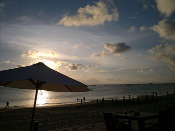 Scenic view of beach against sky during sunset