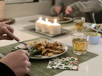 Midsection of woman having food on table