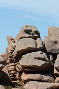 Low angle view of rocks on rock against sky