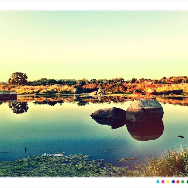 water, reflection, tranquil scene, tranquility, scenics, beauty in nature, sea, sky, nature, standing water, lake, rock - object, clear sky, waterfront, idyllic, rock formation, blue, calm, boat, moored