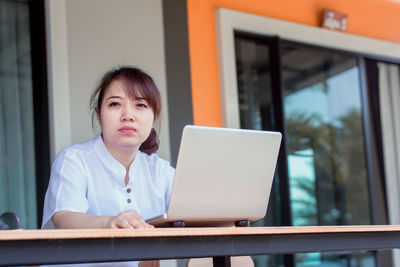 Portrait of mid adult woman using mobile phone