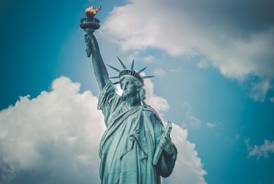 Low angle view of statue against cloudy sky