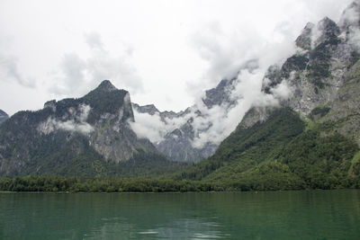 Scenic view of lake and mountains against sky