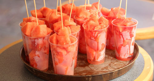 Tray with many glasses of juicy red pieces of ripe watermelon very dissatent in summer