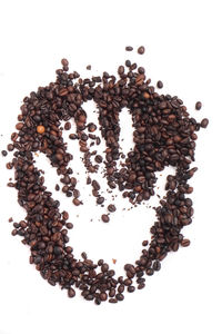 High angle view of coffee beans against white background