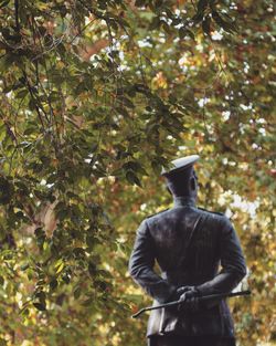 Rear view of statue against trees