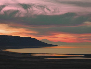 Scenic view of sea against romantic sky at sunset